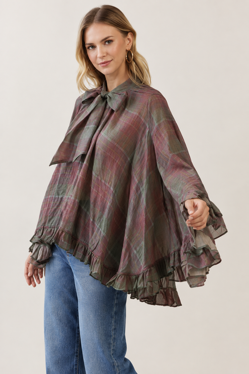 Model wearing TCEC burgundy plaid bow-tie ruffle blouse, angled view
